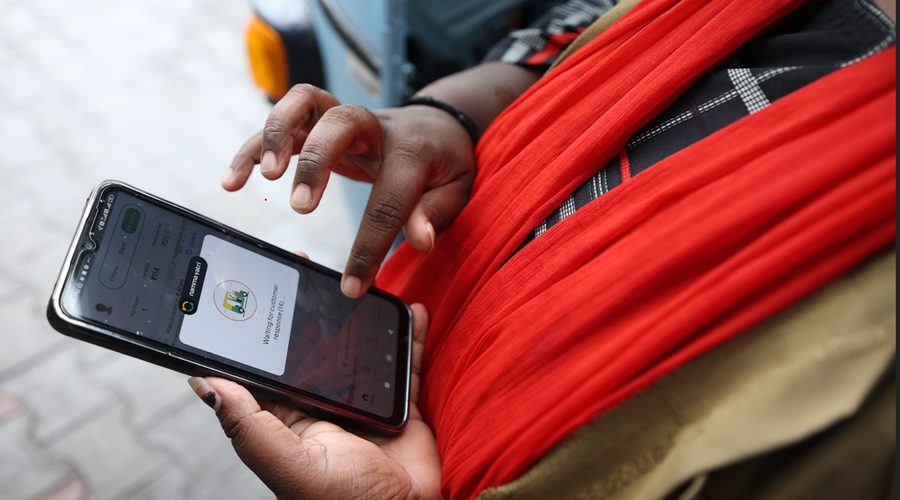 A driver checking the Namma Yatri app on her phone between rides